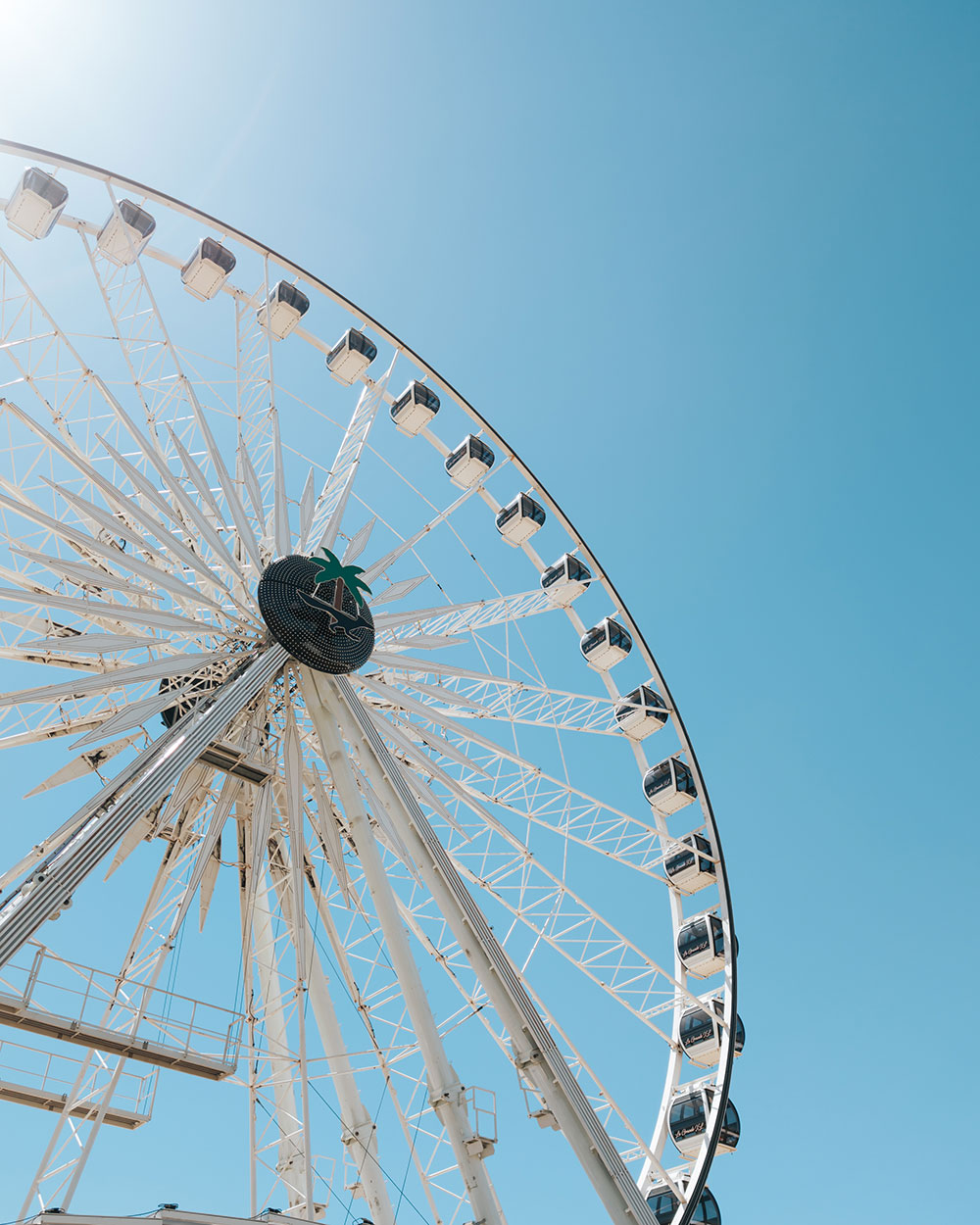 closeup of Coachella ferris wheel against blue sky