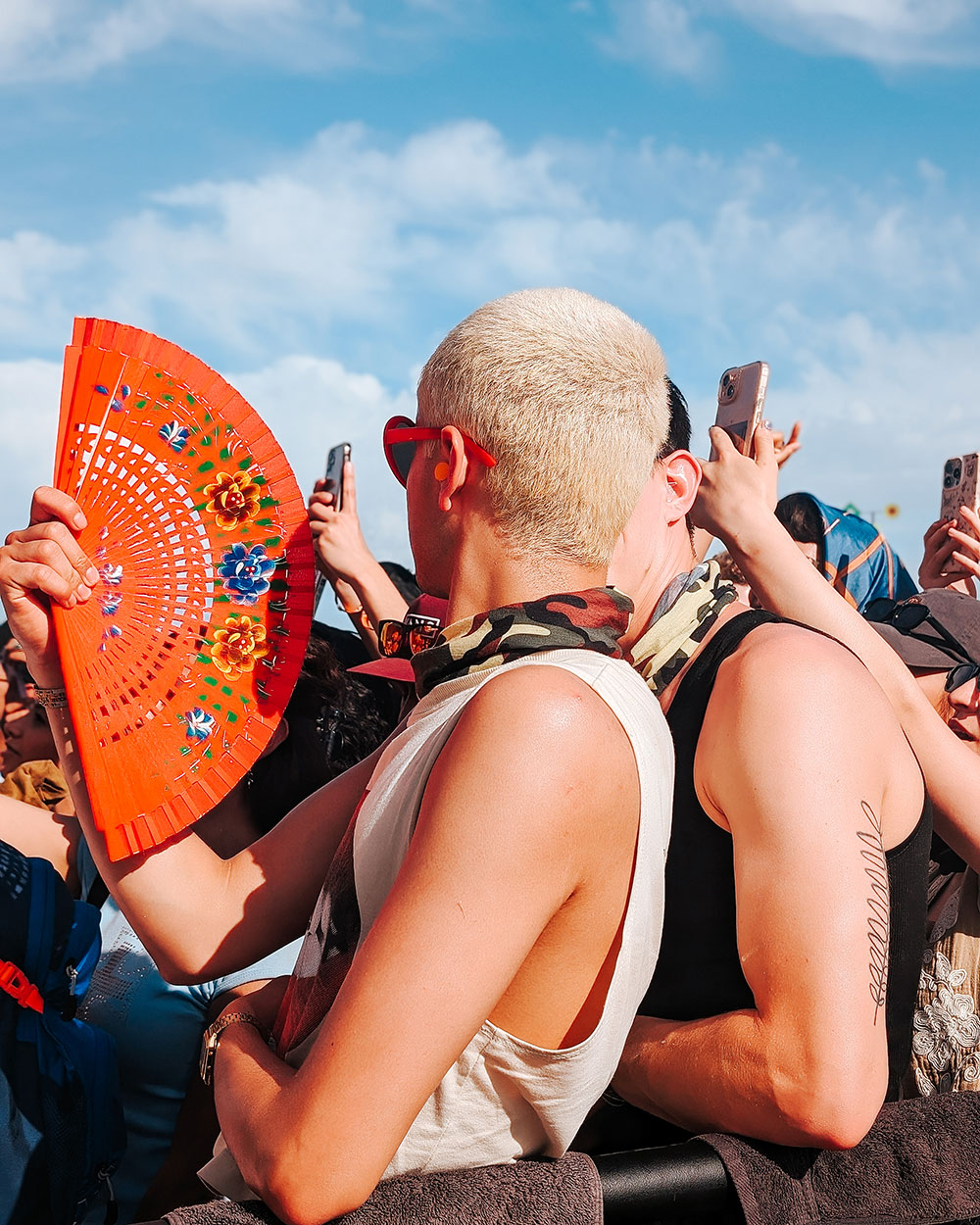 Festivalgoer holding hand fan